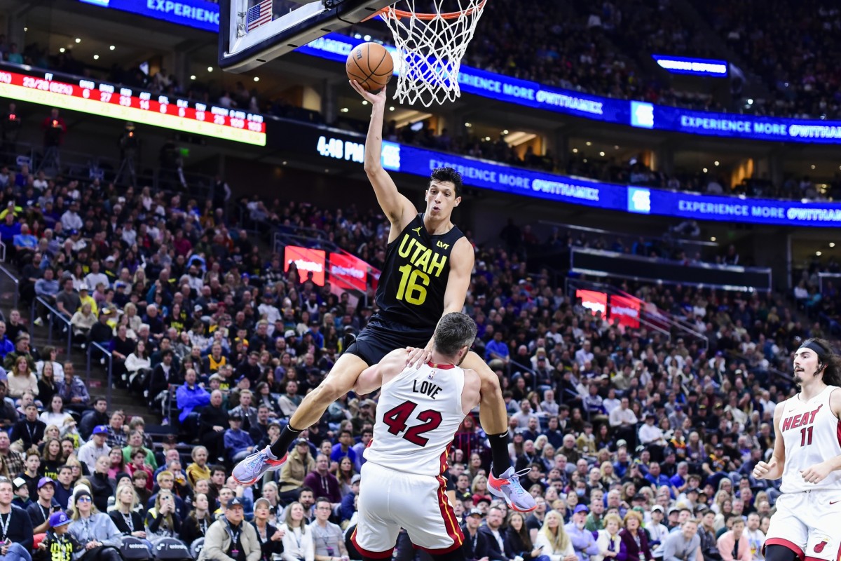 Dec 31, 2022; Salt Lake City, Utah, USA; Utah Jazz forward Simone Fontecchio (16) gets fouled by Miami Heat forward/center Kevin Love (42) during the second half at Vivint Arena. 